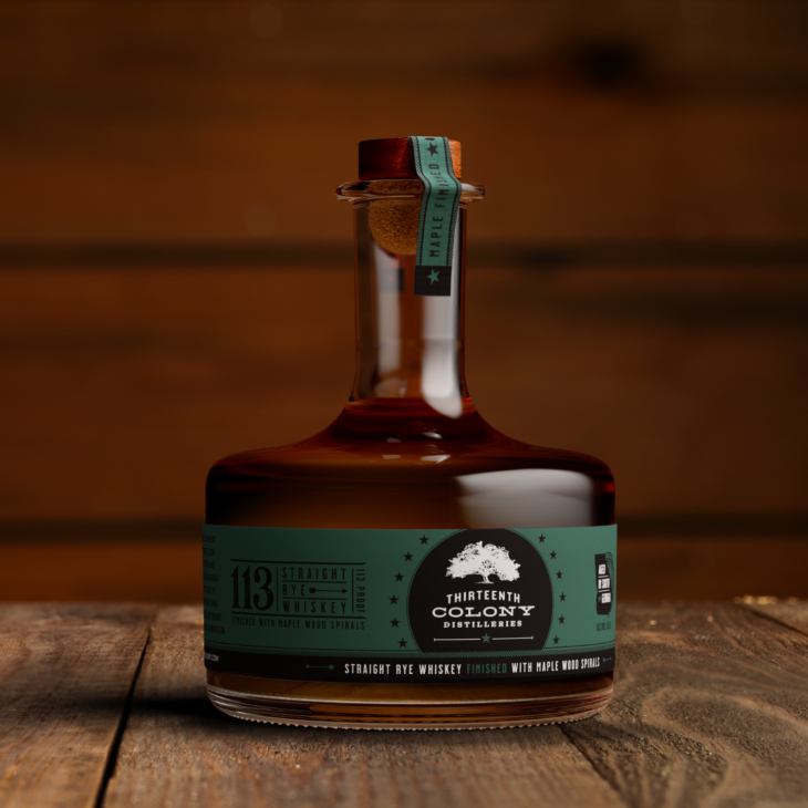 Bottle of whiskey from Thirteen Colony Distillery on a wooden surface with a blurred background